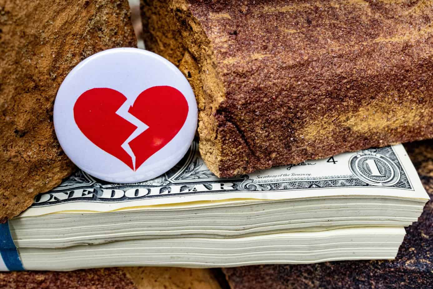 Money and Divorce, advice from Alexander & Associates. Image with broken heart and cash.